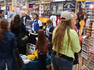 People stop by the booth to ask questions. OEAbootheducation taking place.jpg